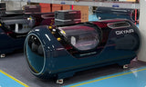 OxyAir OLV-YT01 hard-shell hyperbaric chamber on factory floor showing full unit size and entry door